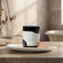 Load image into Gallery viewer, Jar of body scrub with pink salt on a plate in a bathroom setting