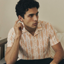 Load image into Gallery viewer, Man sitting on a couch wearing a patterned shirt in a casual indoor setting