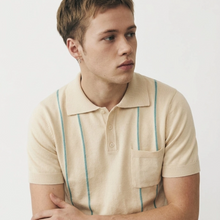 Load image into Gallery viewer, Man wearing a beige polo shirt with blue stripes on a plain background