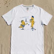 Load image into Gallery viewer, White t-shirt with cartoon characters and Eiffel Tower on sand background