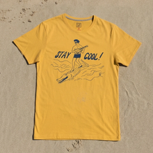 Load image into Gallery viewer, Yellow t-shirt with 'Stay Cool!' graphic on a sandy background