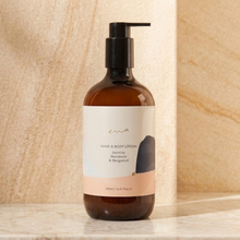 Load image into Gallery viewer, Hand and body lotion bottle with pump on a marble surface
