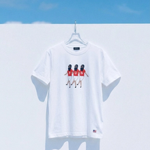 Load image into Gallery viewer, White t-shirt with graphic design on a hanger against a blue sky.