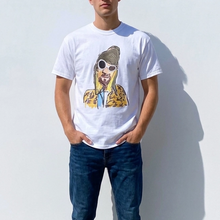 Load image into Gallery viewer, Person wearing a white t-shirt with a graphic design of a person with sunglasses and a jacket, standing against a light gray background.