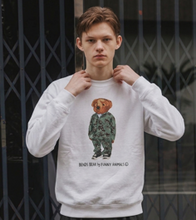 Load image into Gallery viewer, Person wearing a white sweatshirt with a graphic design of a bear and text, standing against a dark background.