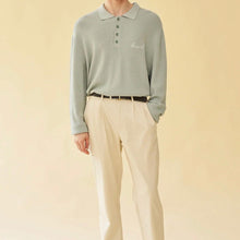 Load image into Gallery viewer, Person wearing a light green long-sleeve polo shirt and beige pants on a beige background