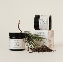 Load image into Gallery viewer, A jar of SEES Shea Butter with its cap removed, placed next to a box and a small container, with a decorative green plant in the background. The label on the jar reads 'Shea Butter'.