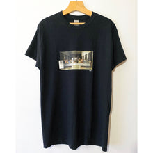 Load image into Gallery viewer, A black T-shirt with a graphic print in the center featuring 'The Last Supper' painting