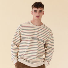 Load image into Gallery viewer, A male model wearing an oyster stripe sweater with a tape print logo on the front.