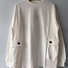 Load image into Gallery viewer, A long-sleeved white crewneck t-shirt displayed on a hanger against a grey background.