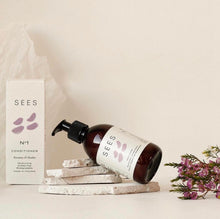 Load image into Gallery viewer, A pump bottle of SEES Company's Conditioner No.1 with heather and rosemary, placed on a small stack of white stones.