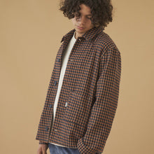 Load image into Gallery viewer, Person wearing a plaid shirt against a beige background